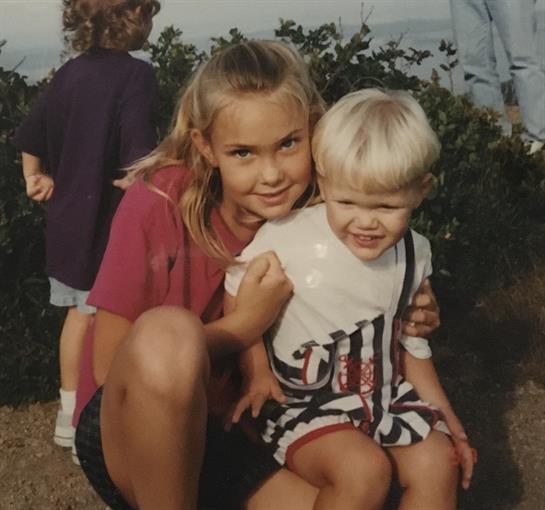 A girl holding a boy