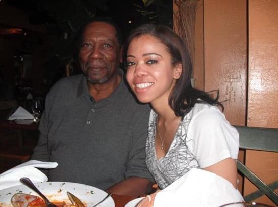 Two friends enjoy a meal together at a cozy restaurant, sharing smiles and a delicious feast.