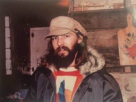 A man with a beard and hat