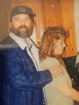 A man and woman standing back to back