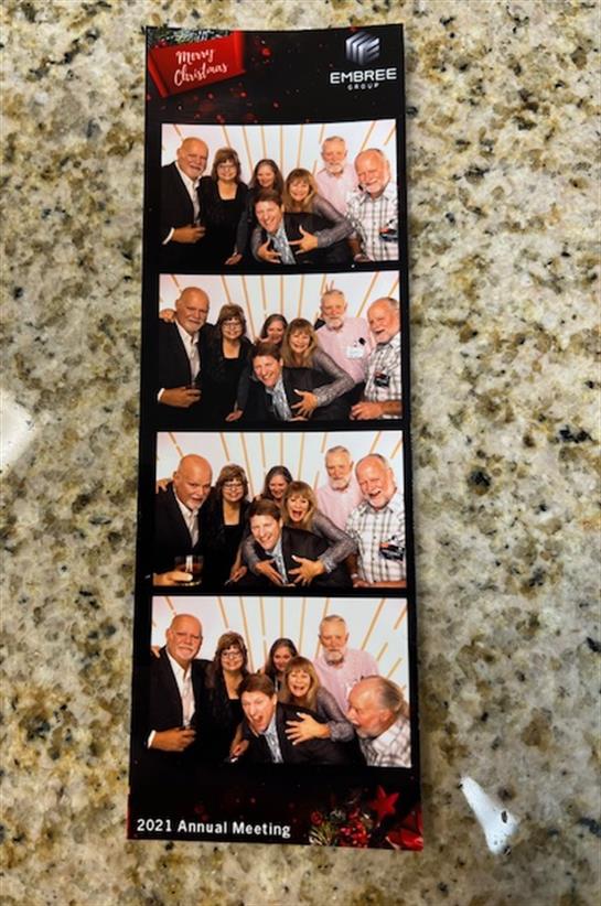 Friends gather for a joyful holiday event, posing playfully at a festive annual gathering.