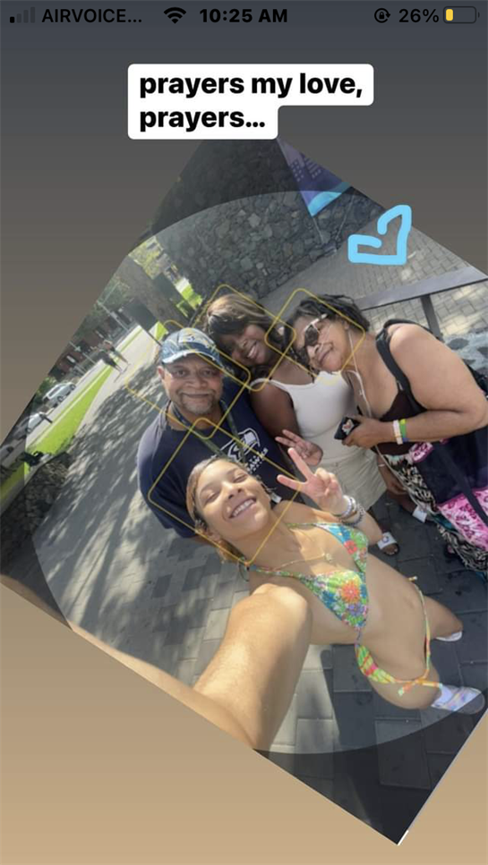 A group of friends poses cheerfully together, uplifting one another under the warm sunlight.