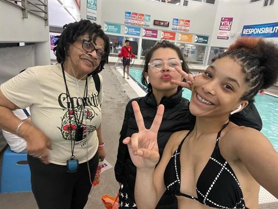 Friends pose happily together at a recreational pool, enjoying a warm afternoon and friendship.