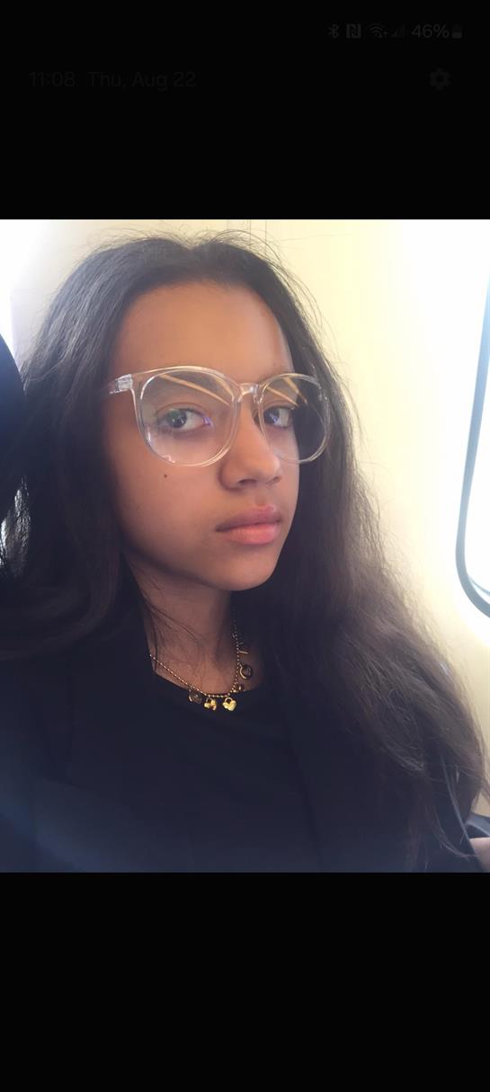 A girl with long hair wearing glasses