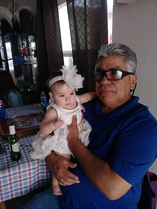 A loving grandfather embraces his granddaughter as they enjoy a cozy family moment together.