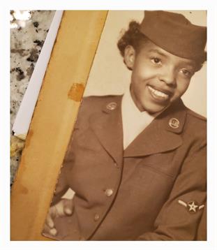 A joyful woman is wearing a military uniform, exuding pride and commitment to her service.
