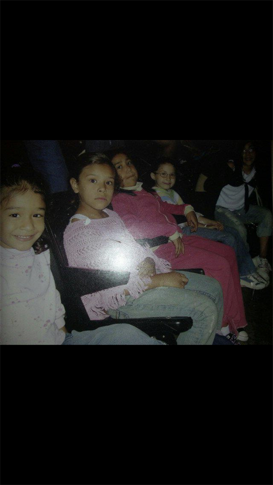 Children sit together in chairs, engaging with each other while sharing smiles and laughter.