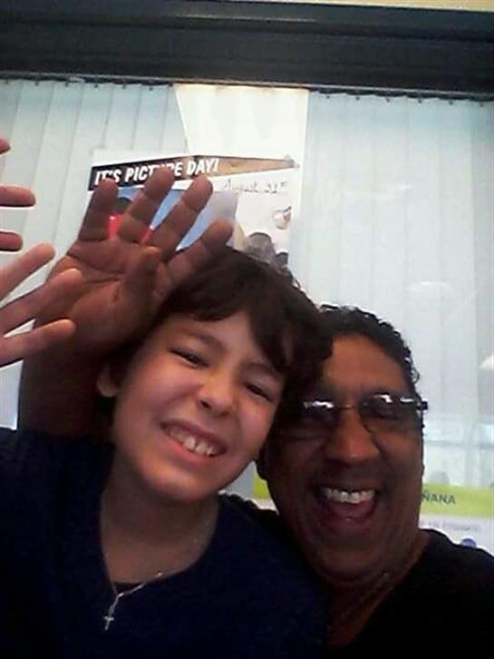 Grandparent and grandchild share joyous moments with laughter and play in a lively cafe.