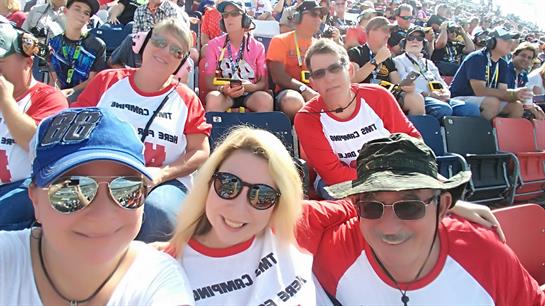 Groups of enthusiastic fans wearing matching shirts gather for an exciting day at a sports event.