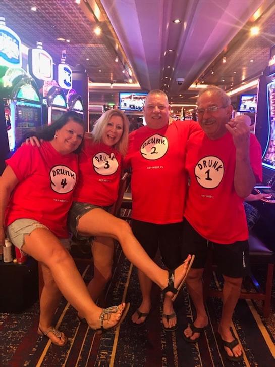 Friends gather at a casino, wearing playful matching outfits and enjoying their time together.