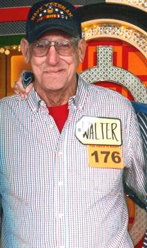 An elderly man named Walter stands proudly holding a price tag in a lively atmosphere.