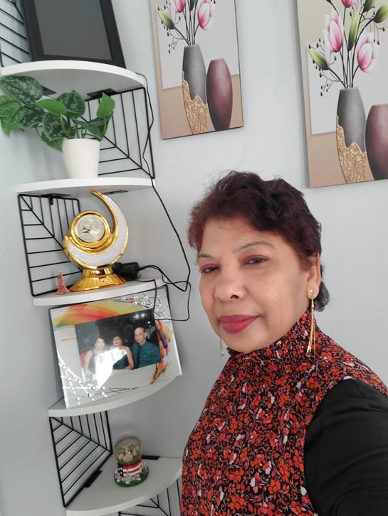 A woman standing next to a shelf