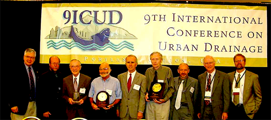A group of men holding trophies
