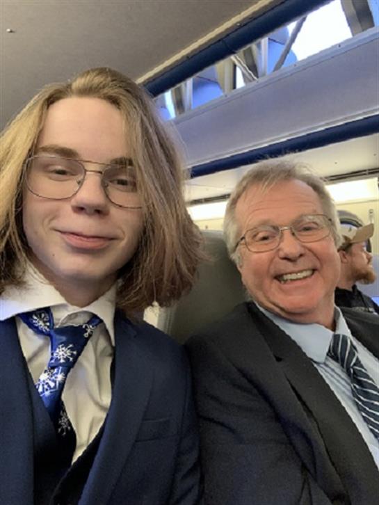 A man and woman sitting on a plane