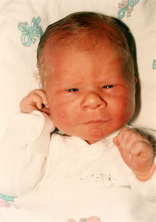 A baby with a wrinkled face