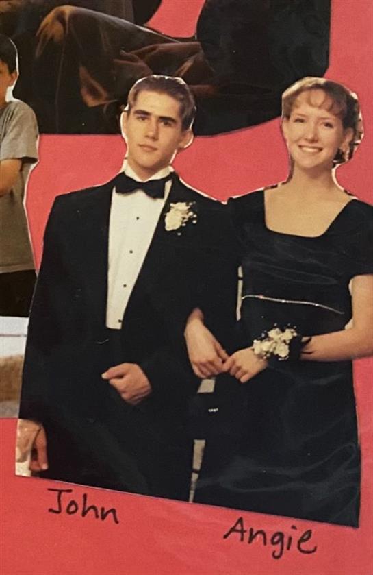 A couple in formal attire celebrates a special occasion in a vibrant setting.