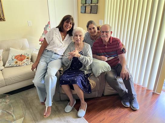 Four family members enjoy a lovely moment together in a bright living room filled with warmth.