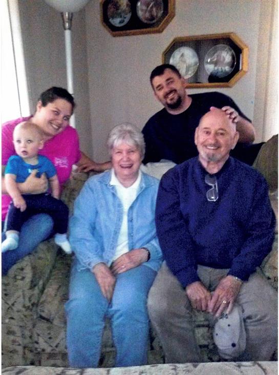 A joyful family enjoys time together in a cozy living room, showcasing love and connection.