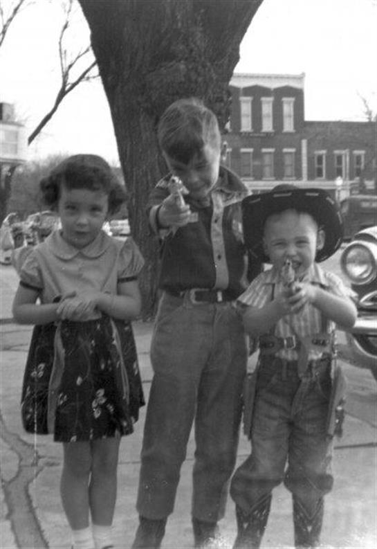 A group of children standing next to a tree