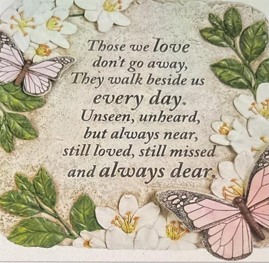 A touching message celebrates the love and memory of those who have passed, surrounded by flowers.