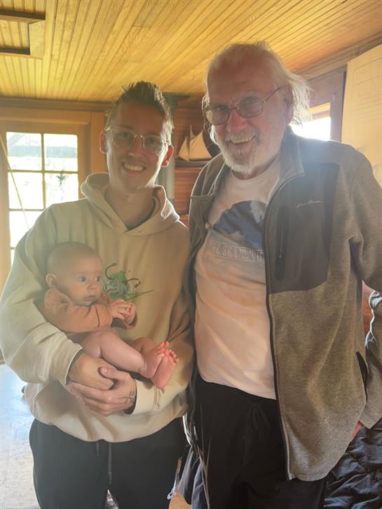 A man and a woman holding a baby
