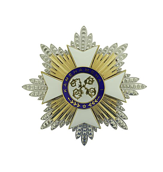 This ornamental insignia features a detailed design in gold, silver, and blue hues.