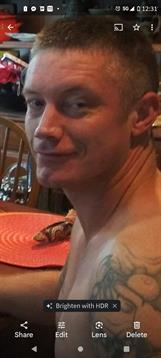 Casual gathering with friends where a man enjoys a meal and shares a moment of joy.