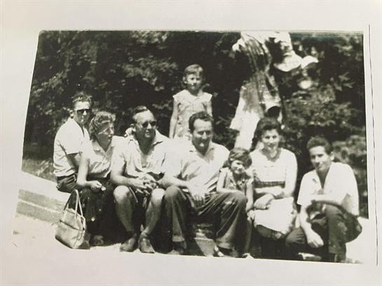 Eight friends gather in the park, laughing and making memories on a sunny day.