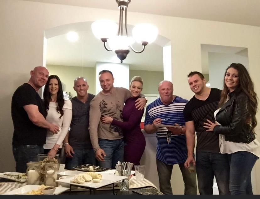 A group of friends is enjoying dinner together in a warm, inviting home setting at night.