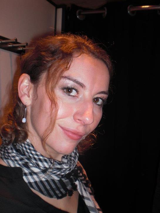 A woman with a scarf and earrings