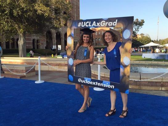 Two women holding a sign