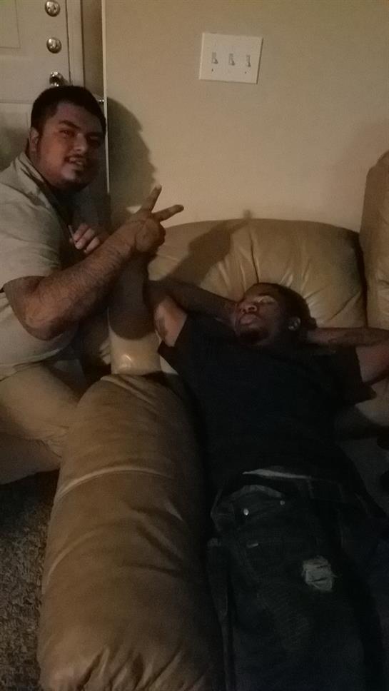 Two friends enjoy a fun moment together on a couch in a cozy living room.