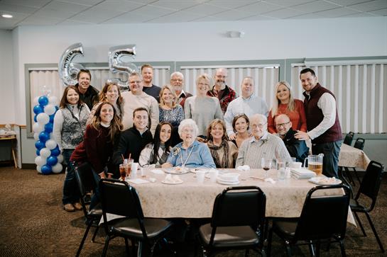 Loved ones celebrate a milestone birthday in a well-decorated venue filled with joy and laughter.