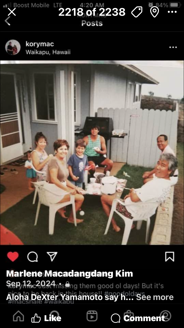 A group of people sitting around a table outside