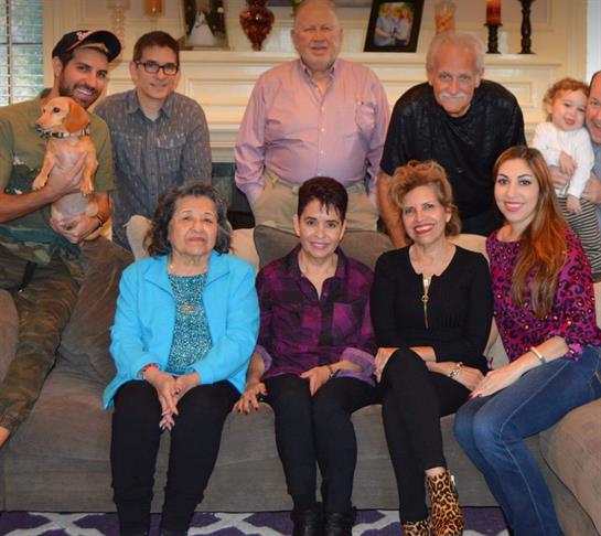 Family members gather together for a cheerful afternoon in a cozy living room, sharing smiles.