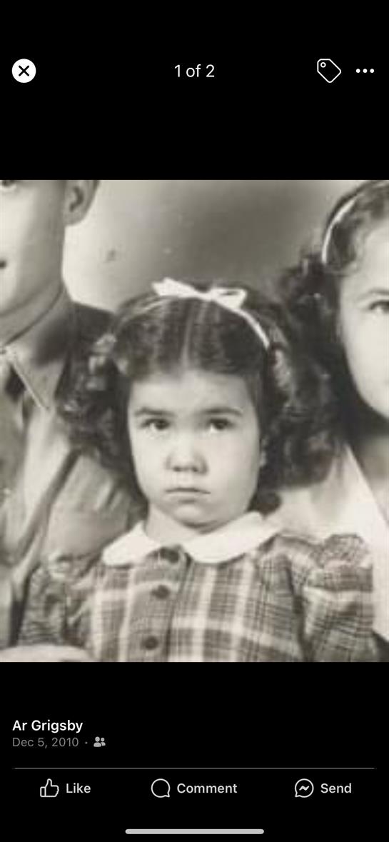 Three siblings in classic mid-20th century attire pose together in black and white.
