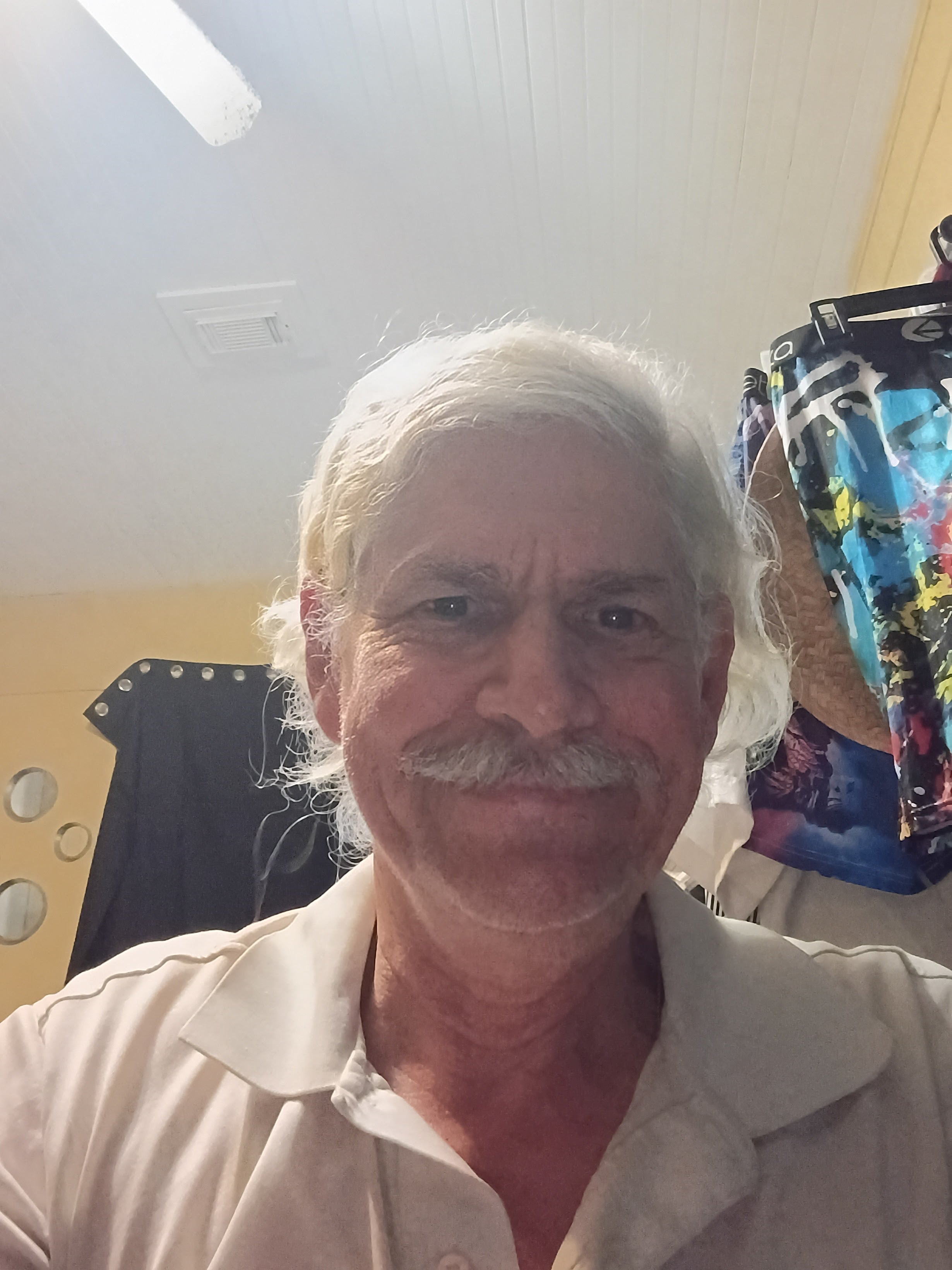 A man with a mustache smiling