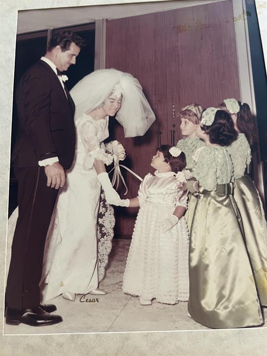 Bride greets children dressed in elegant outfits during a joyful wedding ceremony.