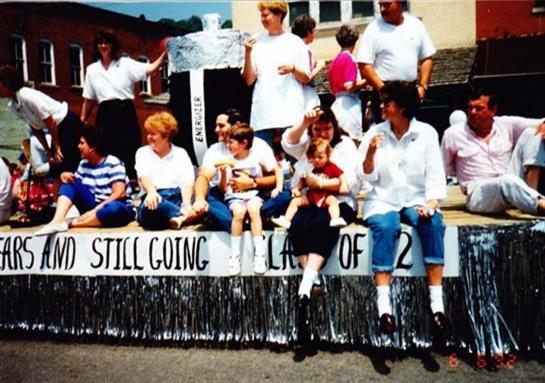 A group of people sitting on a float