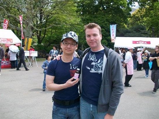 Friends celebrate at a lively festival in a park, showcasing a memorable souvenir together.