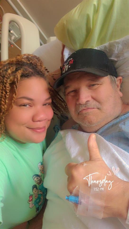 Family member shares a warm moment with a loved one in a hospital room, showing support.