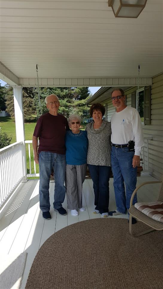 A group of people standing on a porch