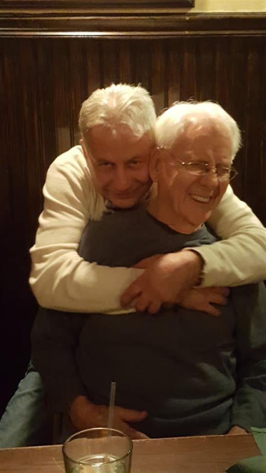 Two men hugging each other