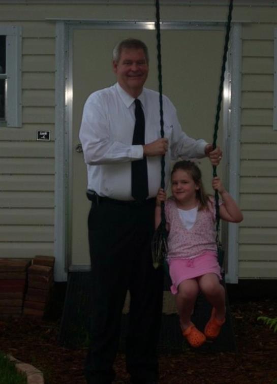 A man and girl on a swing