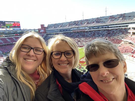 A group of women taking a selfie in a stadium