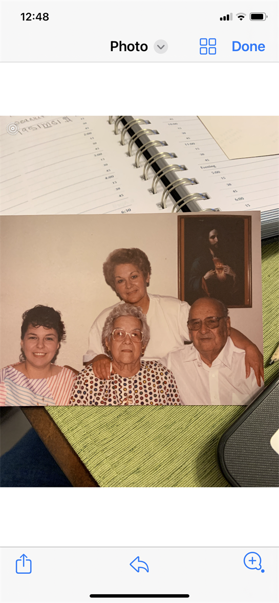 Four family members pose together in a warm living room with a nostalgic atmosphere.