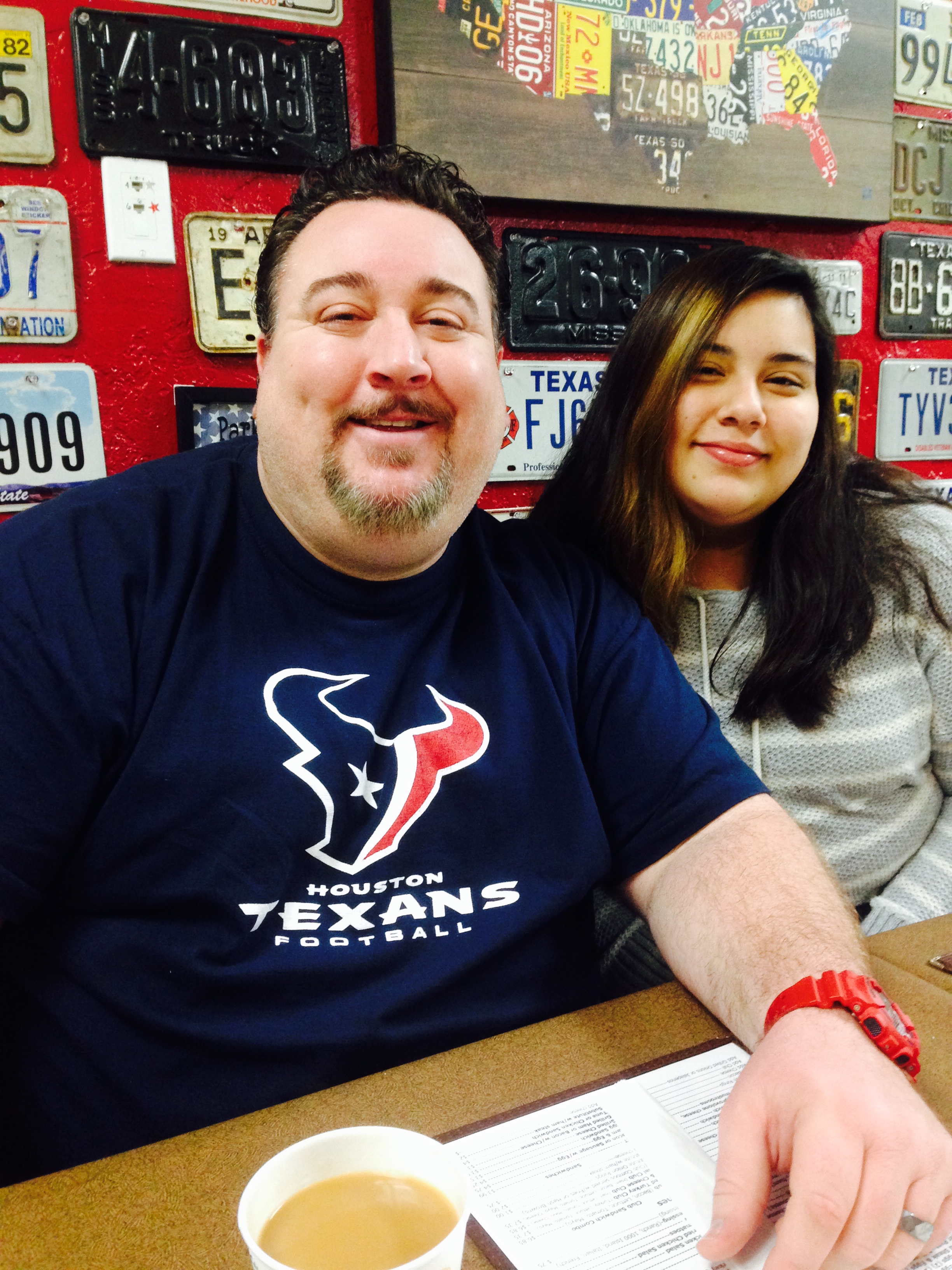 Two people enjoy time together at a restaurant in Houston while smiling and relaxing.
