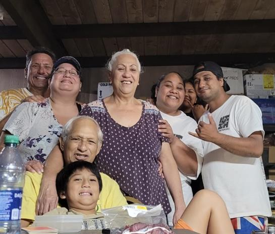 A family enjoys togetherness in a cozy indoor space, sharing smiles and laughter.