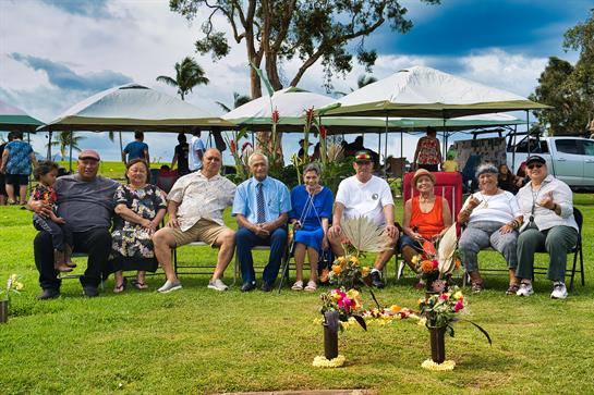 Friends and family gather on benches, joyfully enjoying nature together.