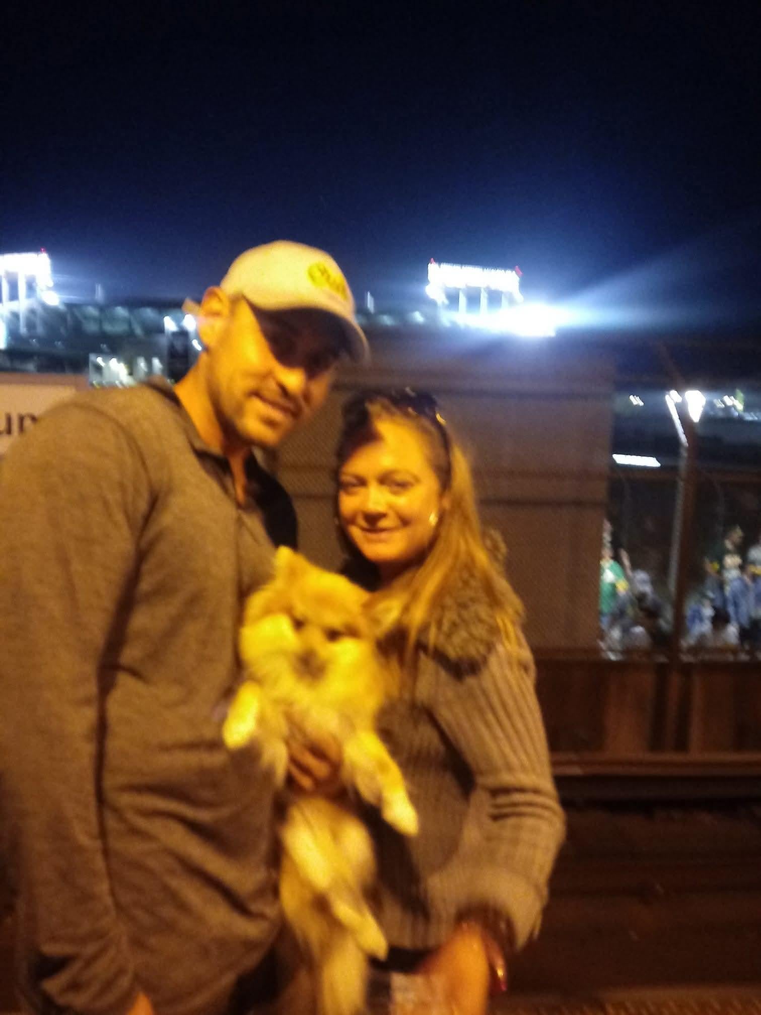 A man and woman holding a cat